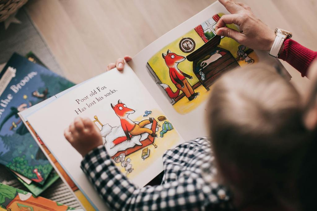 a child reading a book about a fox losing his socks.