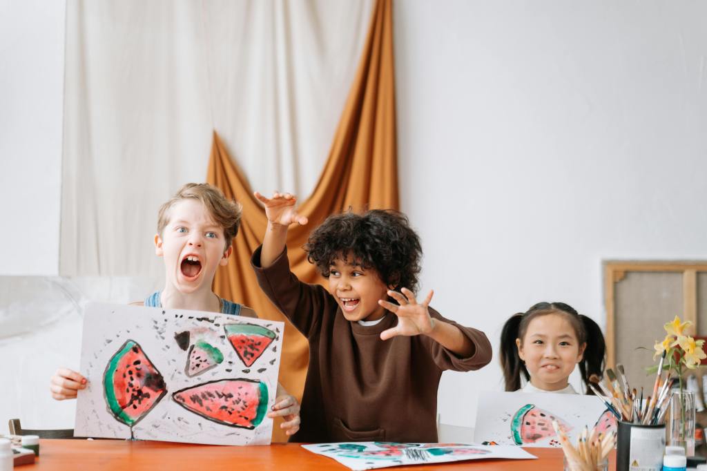 kids painting watermelons on a piece of paper