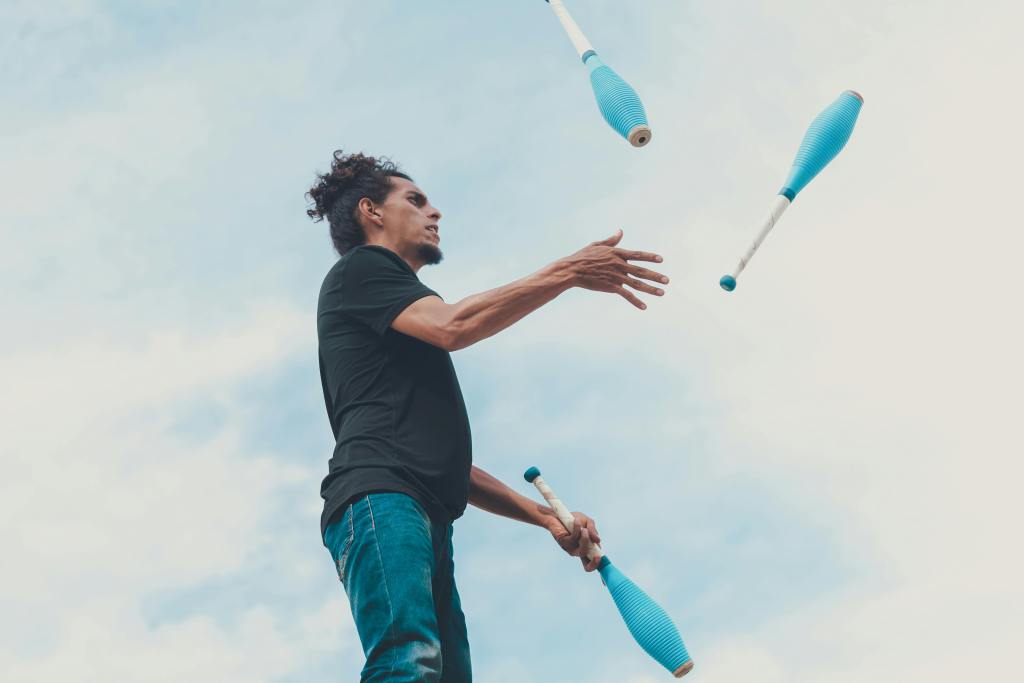 a man juggling with large pins