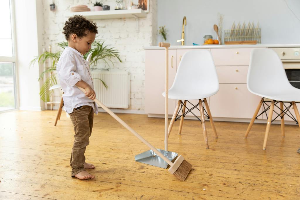 a boy sweeping the floor