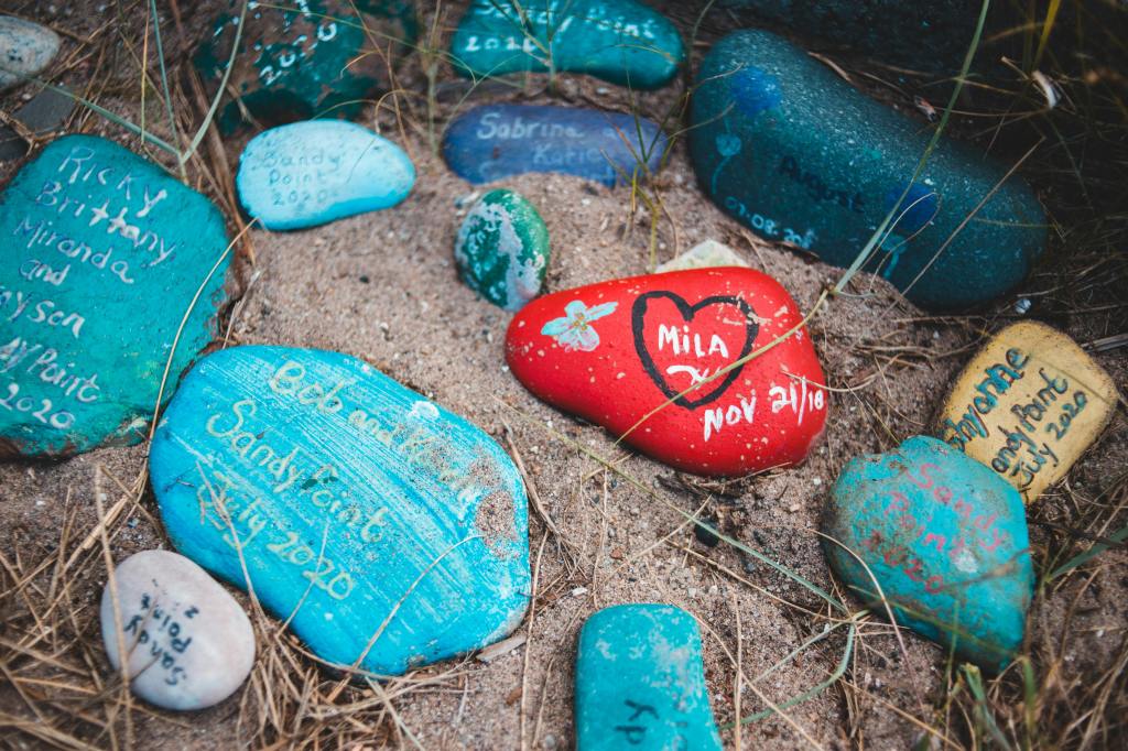 painted rocks with names painted on the rocks