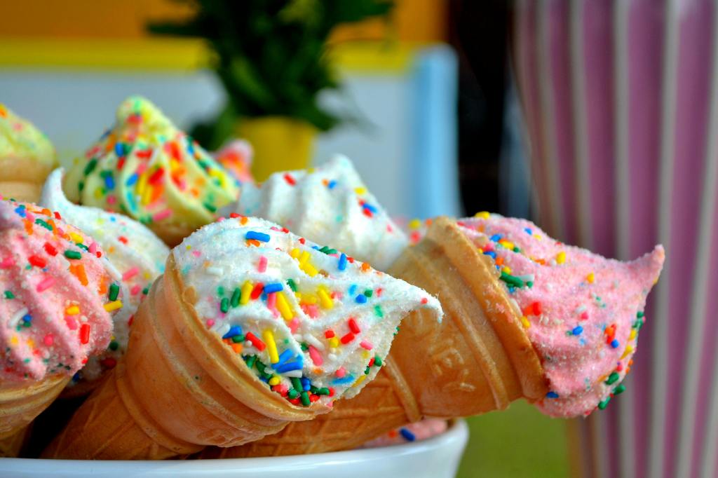 ice cream cones with vibrant color ice cream and sprinkles