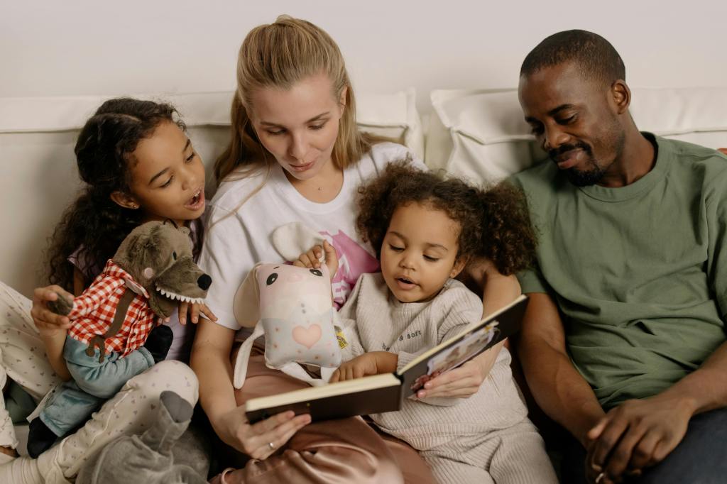 family reading a book on the couch together