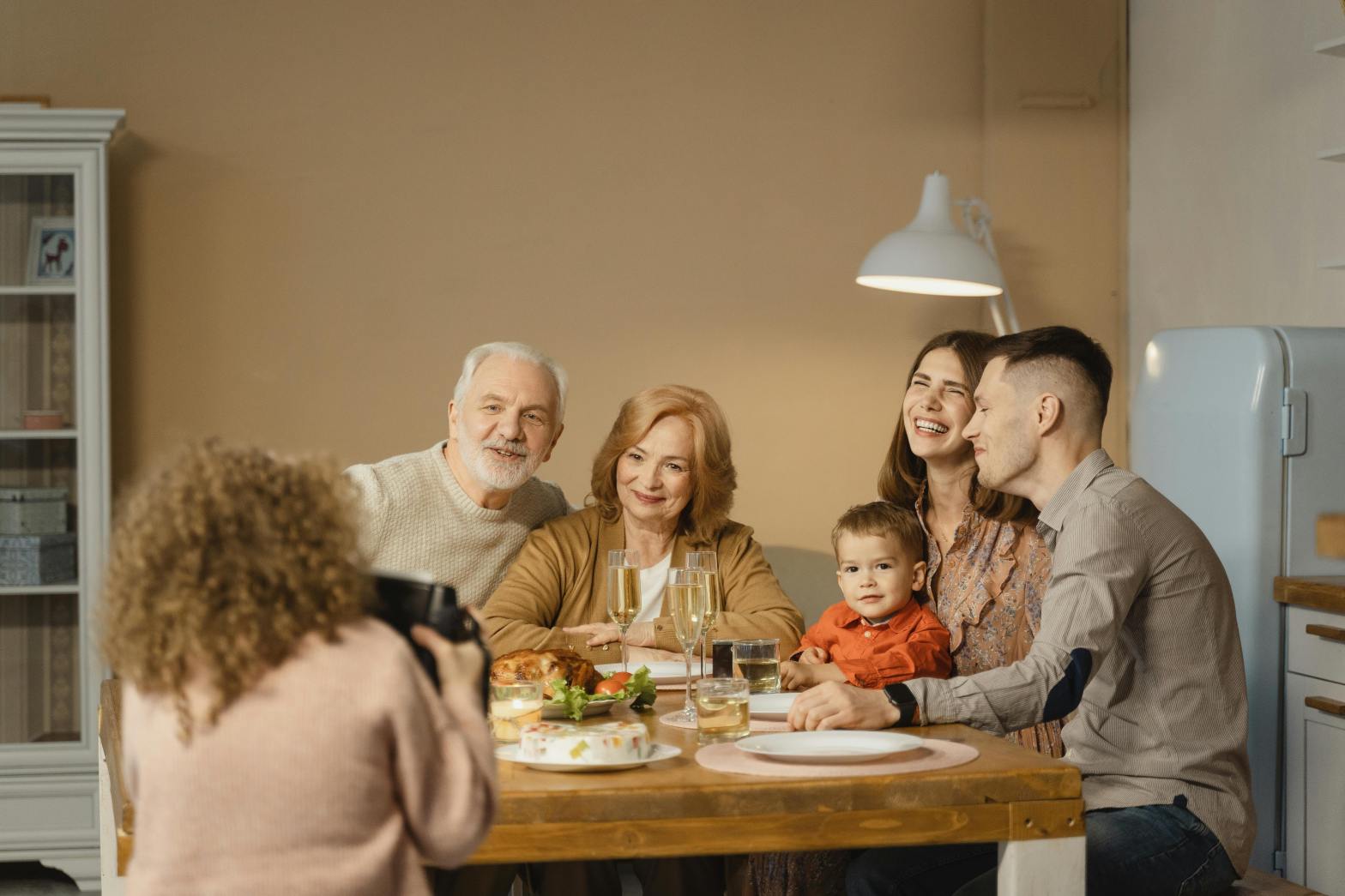 a family posing for a photo around the dinner table