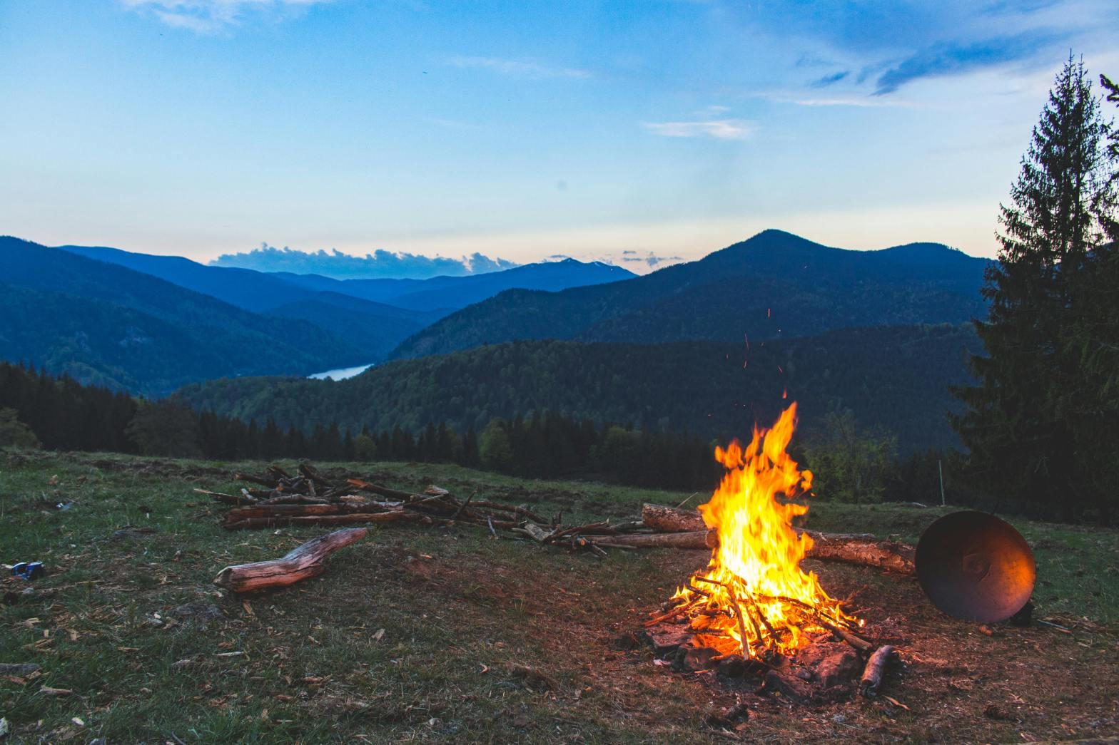 bonfire in an open field overlooking a valley